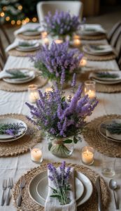 A dining table set with woven placemats, white plates, and utensils, decorated with lavender flower arrangements and lit candles.